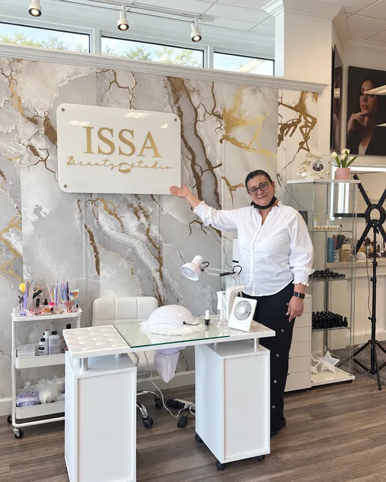 Inside Issa Beauty Studio, by the ISSA sign and the gold-veined marble wall